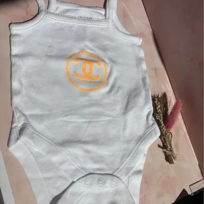 Body bébé Primark neuf – blanc logo orange fluo paillettes – naissance / 1 mois